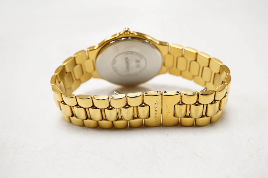 A gentleman's early 1990's stainless steel and gold plated Longines quartz wrist watch, with spare links and box, case diameter 34mm.